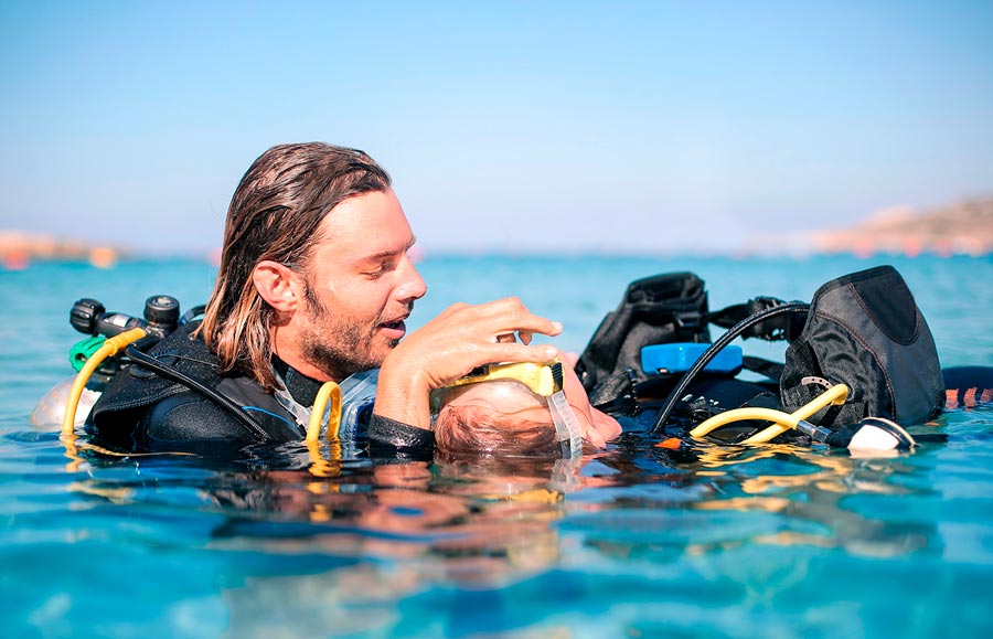A PADI dive instructor with a student